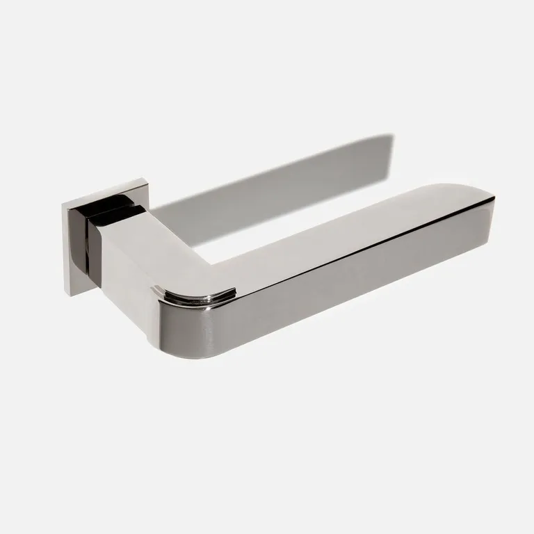 Door handle by Vervloet in steel mounted on a white door surface