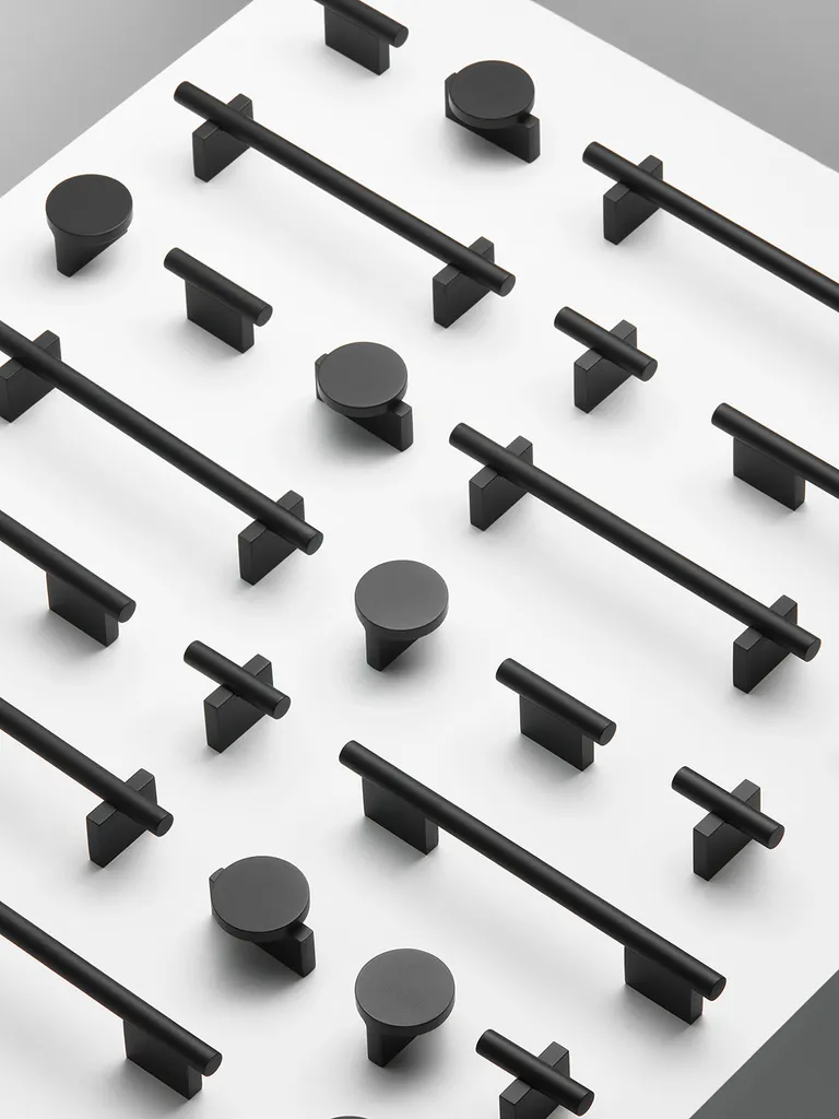 Door Handles by Note Design Studio in black repeated on a pattern on a white background
