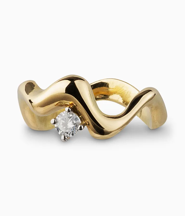 Yellow gold ring with wavy band and diamond on it