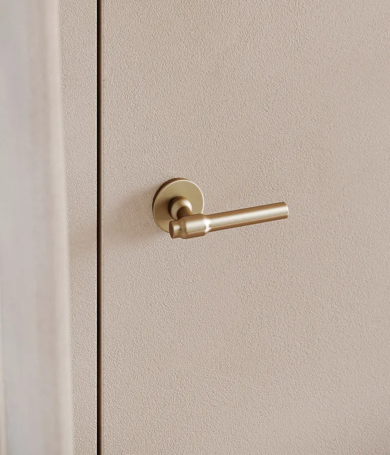 Brass door handle on cream coloured door